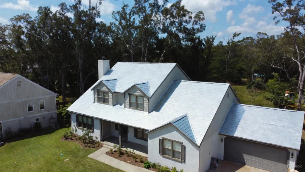 Wide view of a large, flat, white TPO membrane roof installation, used as a visual reference for calculating the overall TPO roofing cost for commercial properties.